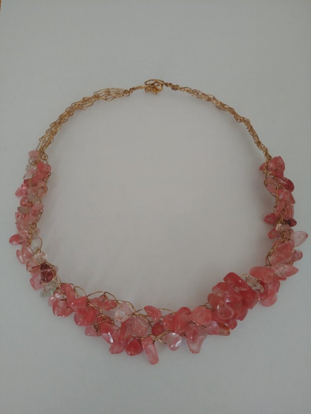 Gold tone wire coil with pink stones short structured collar necklace